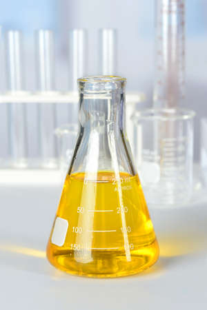 Beaker with yellow colorant on laboratory table