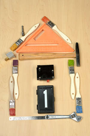 House made out of tools over wooden table