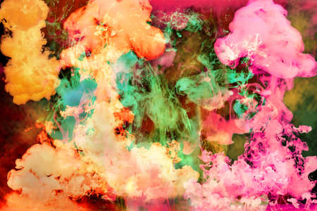 Colorful bright inks disolving in water over a dark backgroundの写真素材