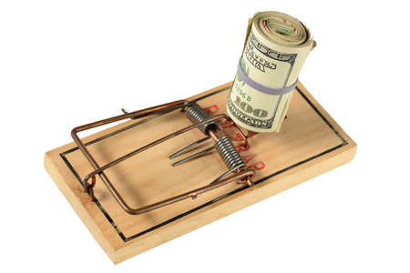 Mousetrap with bundle of dollars isolated over white backgroundの写真素材