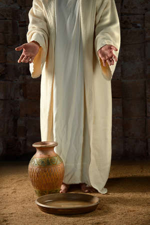 Jesus with water jar and pan inside vintage buildingの写真素材