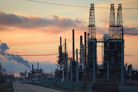 Industrial district with oil refinery at sunset