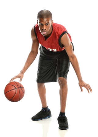 African American basketball player dribbling ball isolated over white backgroundの写真素材