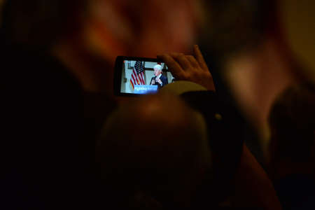Bridgeton, MO/USA - March 08, 2016: Supporter takes video of former president Bill Clinton while...