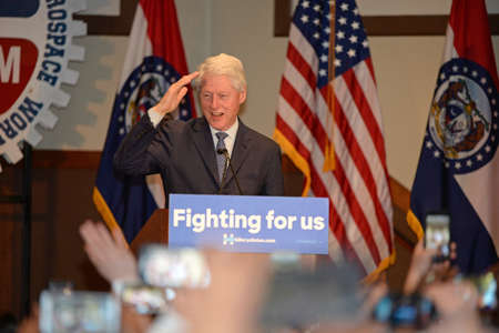 Bridgeton, MO/USA - March 08, 2016: Former president Bill Clinton salutes to supporters while campaigning for his wife and presidential democratic candidate Hillary Clinton, at District 9 Machinists Hall in Bridgeton, a suburb of St. Louis.のeditorial素材