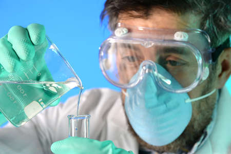Scientist performing experiment with liquids in laboratory