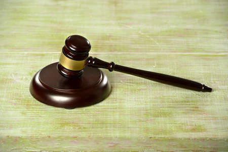 Gavel and base over wooden tableの写真素材