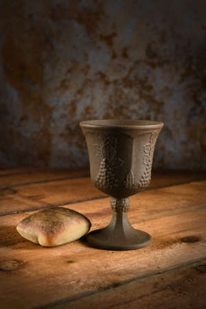 Bread and cup of wine on wooden tableの写真素材