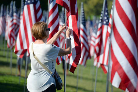Saint Louis, MO â September 11, 2016: More than 7,000 flags with name, photo and dog tag of soldier killed defending the United States wave outside the St. Louis Art Museum in Saint Louis, Missouriのeditorial素材