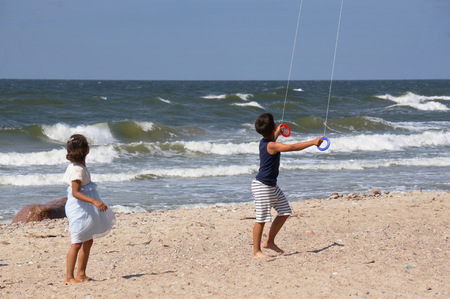 Child flying kite beach outdoor. Summer backgroundの写真素材