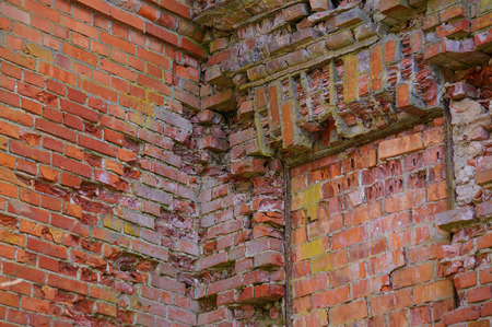 fragment of the old cracking brick wall. Red background.Corner.の写真素材
