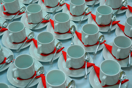 Many rows of pure white cup and saucer designed in vintage retro style. Note: the image contains grain as an element of style.の写真素材