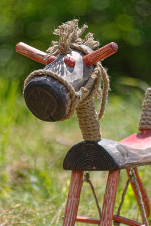 wooden horse on grassの写真素材