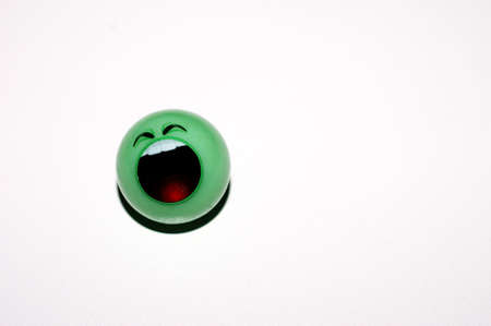 A green marble with a loud face on a white background                     の写真素材