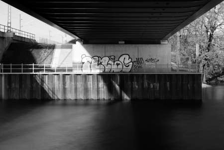 The photograph of a river under a bridge via long time exposure               の写真素材