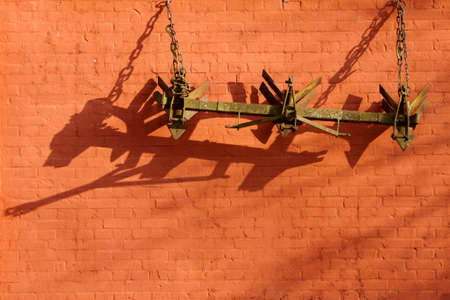plough which hangs on a barn                 