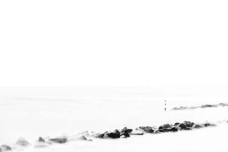 The long time exposure of sea water in a breakwater of stones                      の写真素材