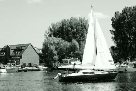 Waren, Mecklenburg Western Pomerania / Germany - June 9, 2013: A sailing ship with unknown people running out of the harbor of the town Waren on the lake Müritz on June 09, 2013 in Waren.              のeditorial素材