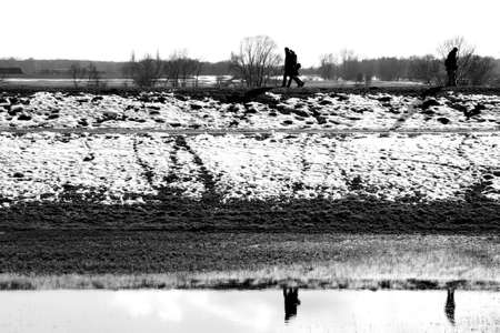 Doemitz, Germany - April 1, 2013: Pedestrians walk on a dike of the river Elbe on 01 April 01, 2013 in Doemitz.                    のeditorial素材