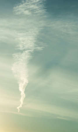 A striking blue sky with contrails can be used as background                    の写真素材