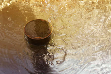 The photograph of a water basin with bubbling water                    