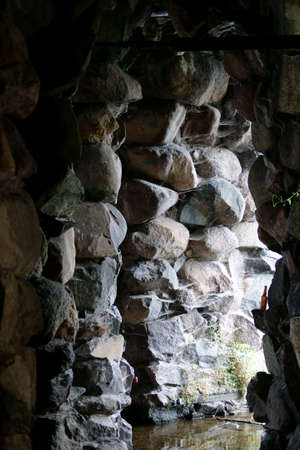 The photograph of the entrance to a field stone grotto                の写真素材