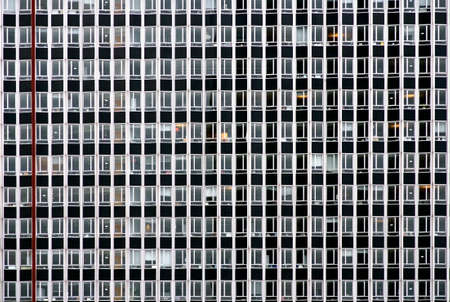 The photograph of a skyscraper facade with many windows                  