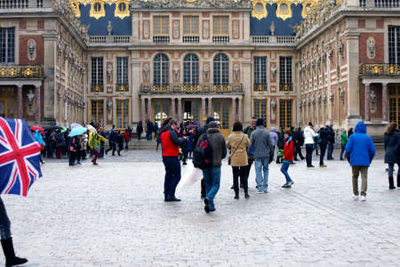 Paris, France - December 30, 2013  Tourists stand and walk in the rain on a square of the Palace of Versailles on December 30, 2013 in Paris                        のeditorial素材