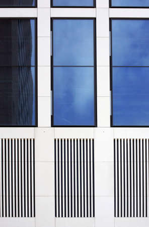 The facade of a modern house with tinted windows and grilles                     