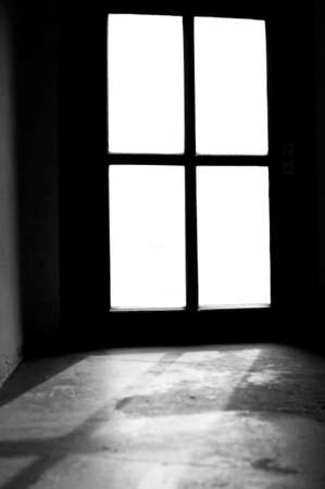 The photograph of a basement window in which light falls                   