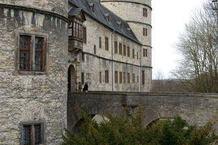 Buren, Germany - March 1, 2014  Two people walking across a bridge in the Wewelsburg on March 01, 2014 in Buren                     のeditorial素材