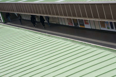 Vienna, Austria - March 30, 2014  Passers-by walk along down the aisle of a covered and plastered platform with posters on March 30, 2014 in Vienna                   のeditorial素材