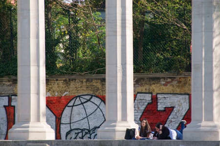 Vienna, Austria - March 30, 2014  Two girls relax and listen to music on the pillars of the Soviet memorial monument on  March 30, 2014 in Vienna                     のeditorial素材