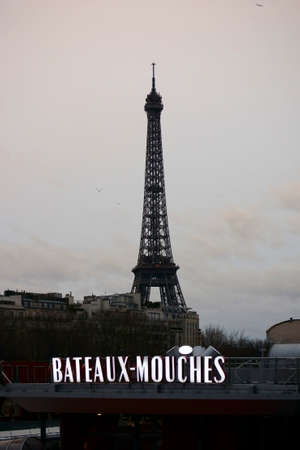 Paris , France - January 01, 2014   The Eiffel Tower and the ships berth for boat trips Bateaux Mouches in the twilight on January 01, 2014 in Paris                 のeditorial素材