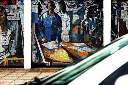 Potsdam, Germany - August 11, 2012   The mosaic painting  Man conquers the cosmos   FRITZ EISEL on the side of a house in Potsdam with a passing car on August 11, 2012 in Potsdam                  のeditorial素材