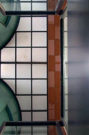 The photograph of a ceiling with ceiling paneling, partitions and tiles                 