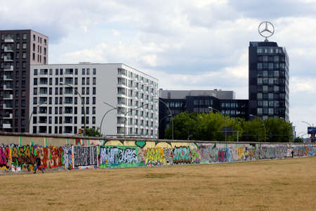 Berlin, Germany, June 16, 2014  The back of the East Side Gallery painted with graffiti with the Mercedes building in the background on June 16, 2014 in Berlin                  のeditorial素材