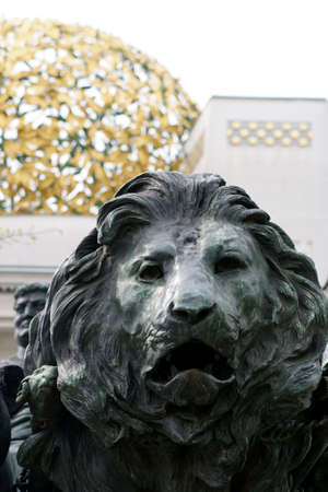 Vienna, Austria - March 30, 2014  The sculpture of a lion at the side entrance of the exhibition hall of the Vienna Secession decorated with gold ornaments on March 30, 2014 in Vienna                   のeditorial素材