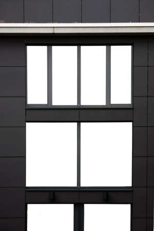 The photograph of a modern house facade with a large picture window                の写真素材