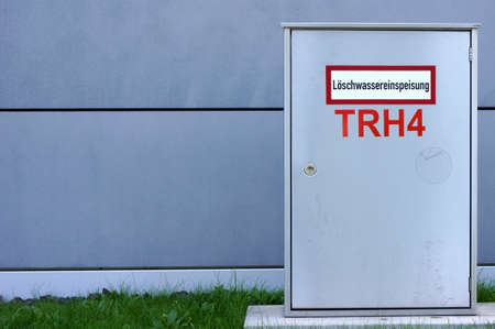 The photograph of a fire water supply and distribution box on a building.