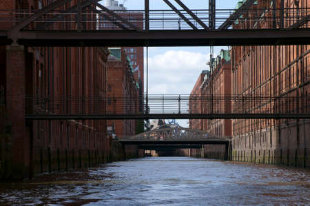 Hamburg, Germany - September 22, 2014: A channel of the listed city of warehouses in Hamburg with bridges between the buildings on September 22, 2014 in Hamburg.のeditorial素材