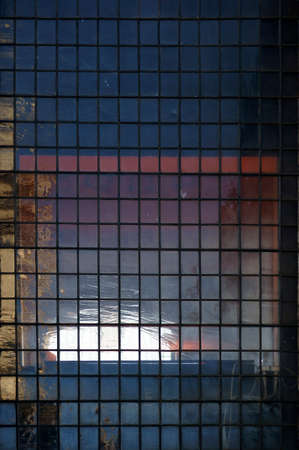 A window with lots of smaller windows with abstract reflections.の写真素材