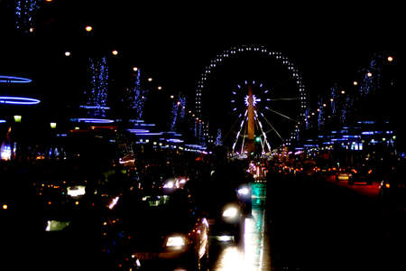Paris, France - December 30, 2013: The Christmas decorated Champs Elysees at night with car traffic and the Ferris wheel at its end on December 30, 2014 in Paris.のeditorial素材
