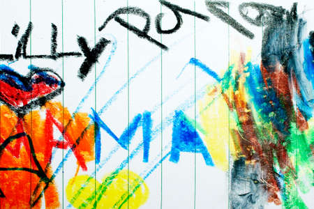 The doodles and paintings from a toddler with a colored pencil on paper.の写真素材