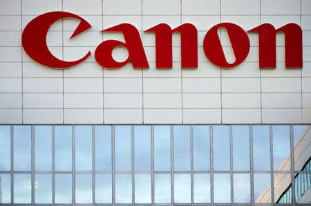 Amsterdam, Netherlands - December 30, 2014: The company\'s logo from Canon on a modern facade of an...