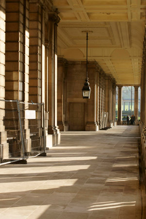 London, UK - November 29, 2014: Column throw shadows in a corridor of the Royal Naval College in Greenwich where tourists standing at this end on November 29, 2014 in London.のeditorial素材