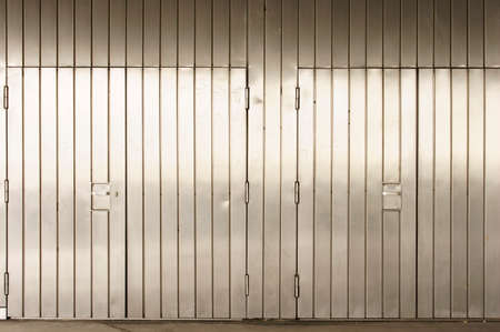 A striking stainless steel wall with sealed entrance gates.の写真素材