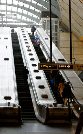 London, UK - November 29, 2014: People rely on escalator at the subway station Canary Wharf on...