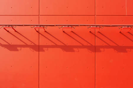 The lamp frames a striking red facade cast a shadow.の写真素材