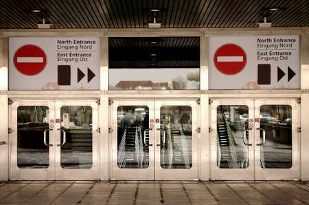 The shiny metallic entrance doors of a convention center on a fairground.のeditorial素材